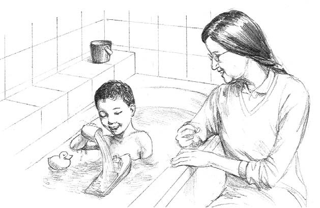 A young boy plays in a bathtub while his mother watches. He's pouring a cup of water onto a toy boat and seeing how it sinks.